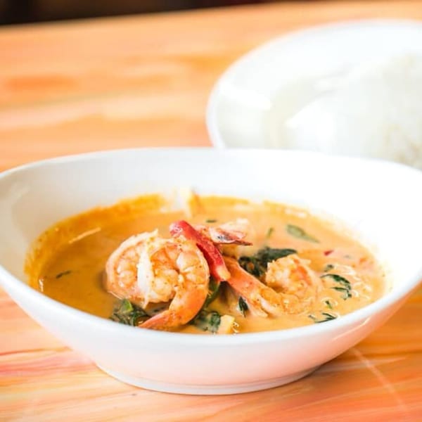 Nisa Thai Asian Cuisine's red curry with shrimp and basil, served with white rice.