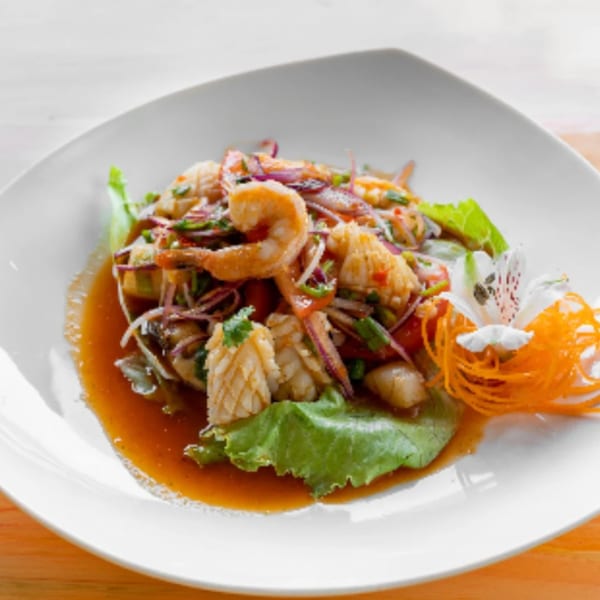Nisa Thai Asian Cuisine's spicy seafood salad with shrimp, squid, red onions, and herbs.