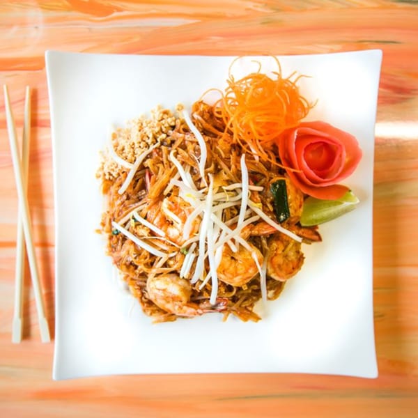 Nisa Thai Asian Cuisine's Pad Thai with shrimp, bean sprouts, peanuts, and a carrot garnish.